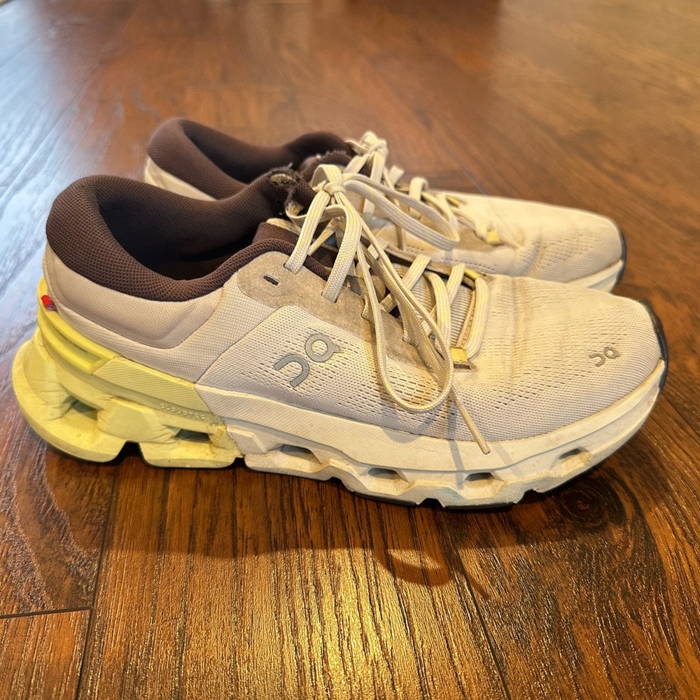 On Running Cream and Yellow Athletic Shoes